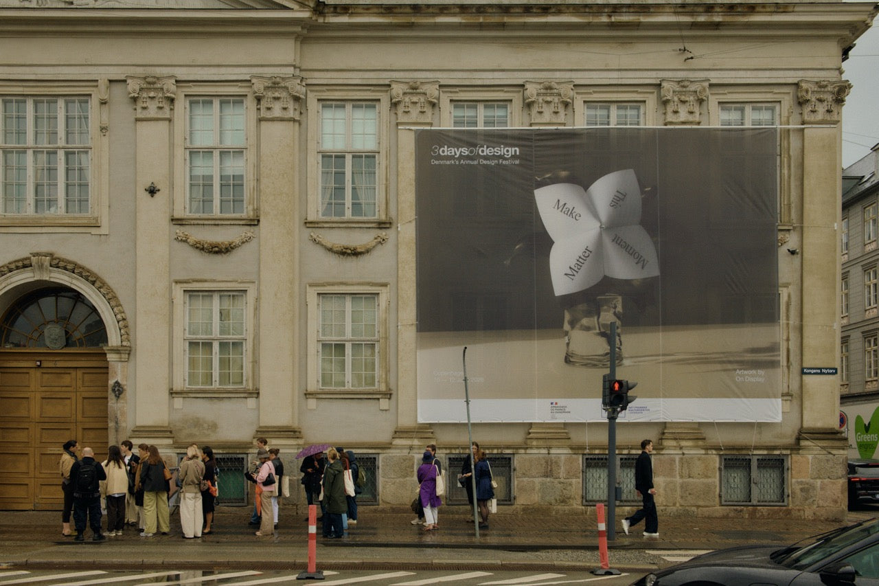 Visitors crossing the street beneath a 3 Days of Design banner in central Copenhagen